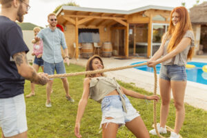 Friends participating in limbo dance contest