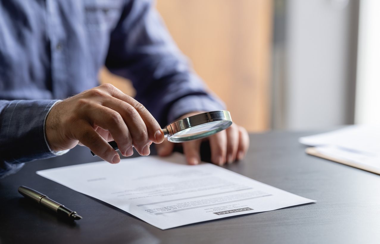 Businessman Signing Legal Paper In Office