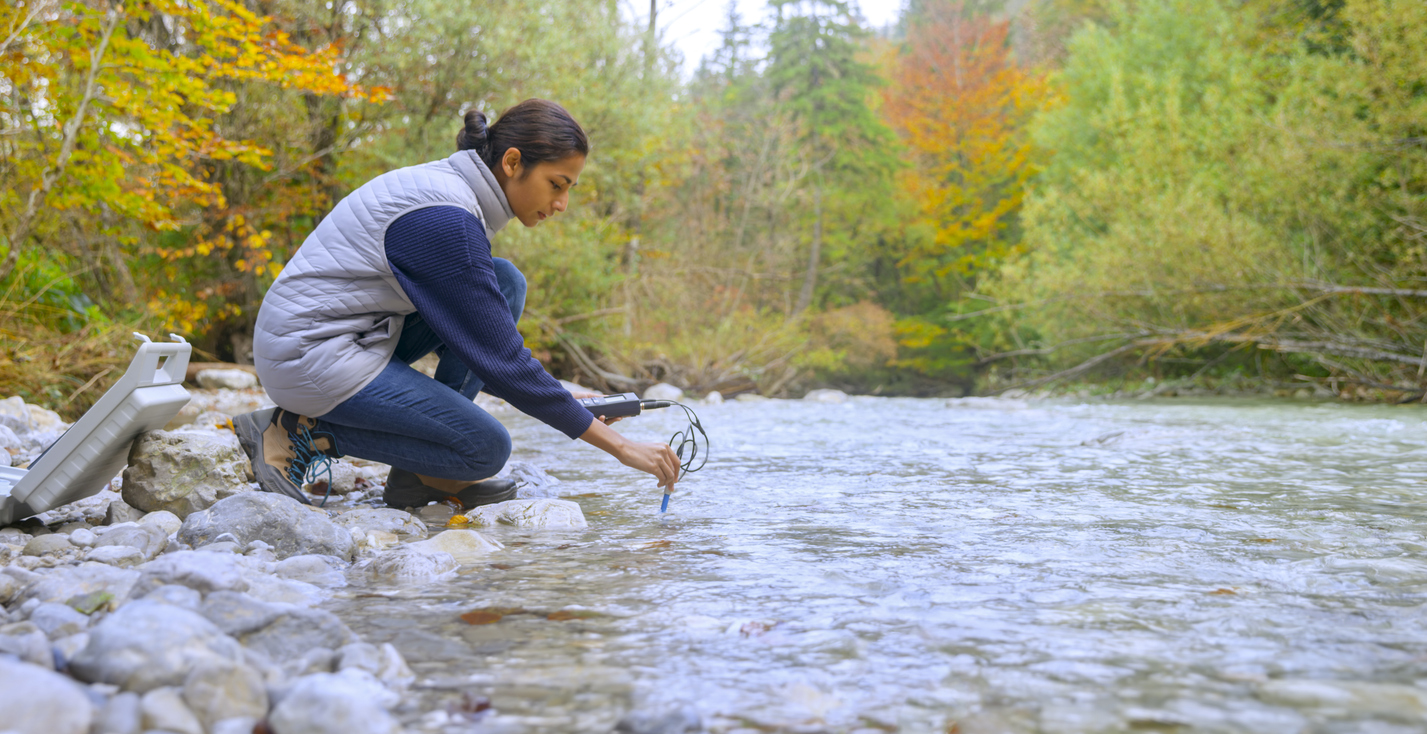 Female biologist testing the oxygen levels in the river